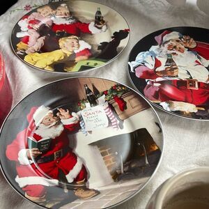 Lot of 3 Coca-Cola Santa plates in original box.